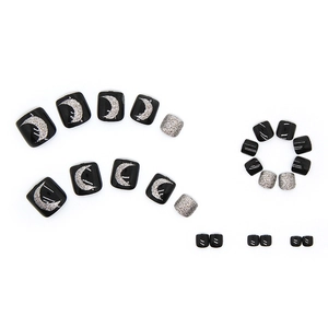 Sparkly black toe nail press-ons with silver moon patterns and glitter finish