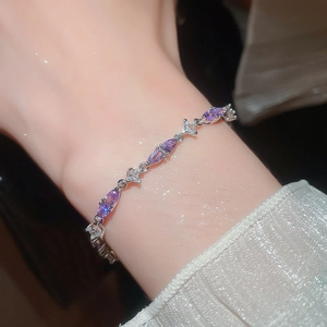 Detail of elegant silver bracelet featuring purple marquise and clear square zircons