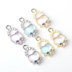 Minimalist heart-shaped charms with colorful stones, pearls, and bow detailing for DIY jewelry