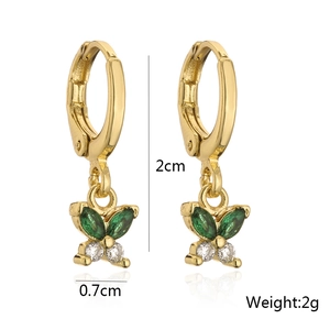 Detail view of gold butterfly earrings with green zircon wings and size measurements