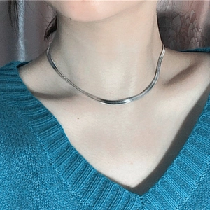 Minimalist silver 316L stainless steel flat snake chain necklace on female model