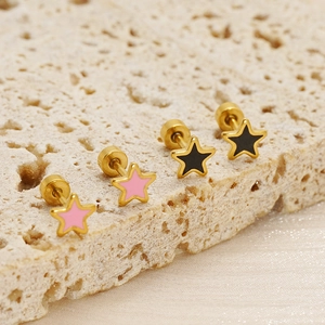 Detailed close-up of pink and black star stud earrings with gold-plated stainless steel edges