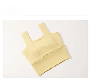 Close-up of wide straps and elastic hem on a pale yellow sports bra for fitness