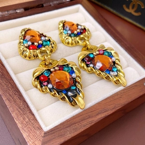 Vintage baroque triangle earrings with orange gemstones in a luxury wooden jewelry box