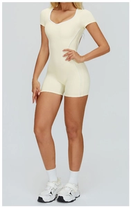 Front view of a yellow short-sleeved athletic jumpsuit with white trim and slim fit