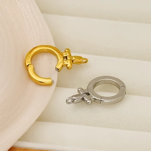 Detailed view of polished 18K gold and silver spring ring clasps for DIY jewelry making