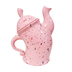 Detailed view of pink ceramic canister with red and black spots on a white background