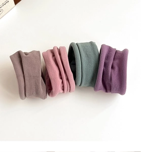 Close-up of four Morandi colored high elastic seamless hair ties in a neat row