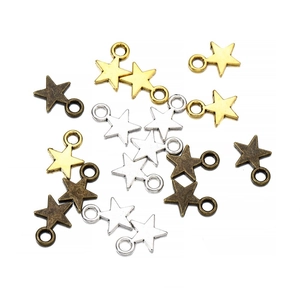 Detailed macro shot of star-shaped alloy pendants in gold, silver, and bronze colors