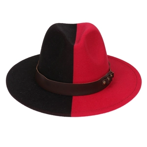 Detail of red and black split wool fedora with brown leather band and metal studs