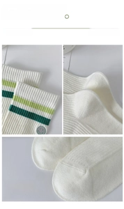 Detailed views of white striped socks featuring high elastic cuffs and smiley face patches