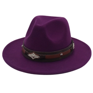 Detail of dark purple felt fedora hat featuring a brown leather band and vintage metal studs