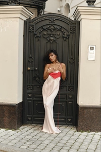 Detail of satin maxi dress featuring lace-trimmed red contrast bodice and slim straps