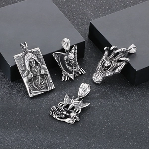 Detailed view of four gothic stainless steel skull and devil claw necklace pendants