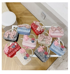 Detailed view of tweed crossbody bags featuring pearl handles and assorted bow ornaments
