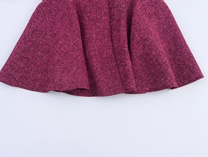 Detail of fuchsia tweed skirt hem showing premium woven texture and A-line silhouette