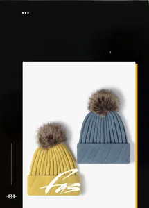 Detail of knit beanies in yellow and blue with fluffy faux fur pom-poms and ribbed texture