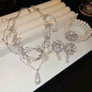 Elegant floral rhinestone and teardrop pearl necklace set with matching bracelet and earrings