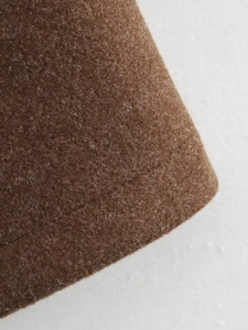 Detailed macro view of the brown wool jacket fabric texture and professional stitching