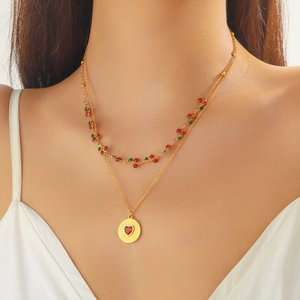 Double-layered gold necklace featuring red cherry charms and a heart pendant for women