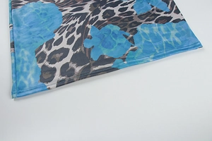 Nahaufnahme von Leoparden- und Wellenprint auf leichtem Sommerkleid-Stoff mit Naht