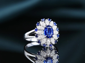 Macro shot of a heavy 2ct oval blue sapphire ring with sparkling floral diamond halo