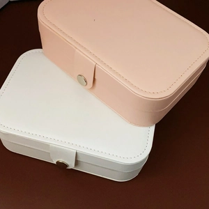 Pink and white PU leather jewelry boxes stacked with metal snap closure detail