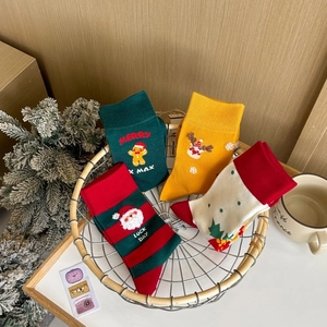 Set of four cotton Christmas socks with gingerbread man, elk and Santa patterns