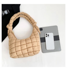 Detailed top view showing beige puffer bag size with tablet and smartphone reference