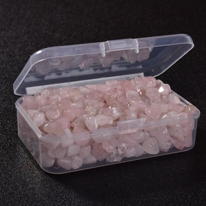 Detail of irregular pink crystal stones in a clear storage box for DIY jewelry making