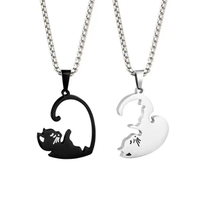 Minimalist puzzle cat couple necklace in black and silver metal on white background