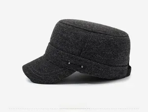 Side view of dark grey flat top army cap showing thick fabric texture and leather tag