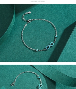 Detail of S925 silver infinity bracelet with turquoise stones and adjustable lobster clasp
