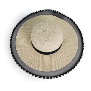 Detailed top view of a wide brim straw hat featuring pearl edging and black mesh trim