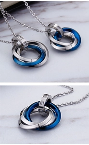Macro detail of interlocking tricolor rings pendant with sparkling diamonds on marble surface