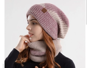 Close-up of dual-tone chunky knit beanie and neck warmer with a brown leather mountain tag