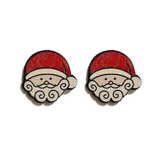 Detail view of cartoon Santa Claus wooden earrings with festive red and white patterns