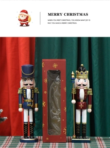 Detail of red and blue 38cm wooden Nutcracker soldiers in festive Christmas packaging