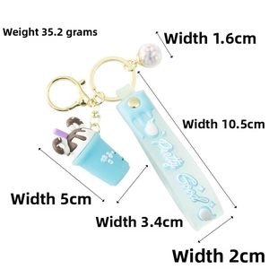 Detail of light blue bubble tea keychain with soft rubber strap and gold spring clasp