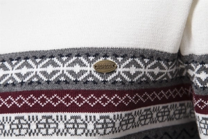 Macro shot of geometric jacquard knit pattern and metal brand tag on men's sweater