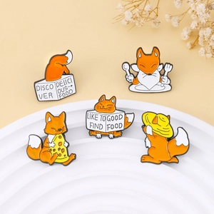 Set of 5 cute orange fox enamel pins with food motifs on a white display tray