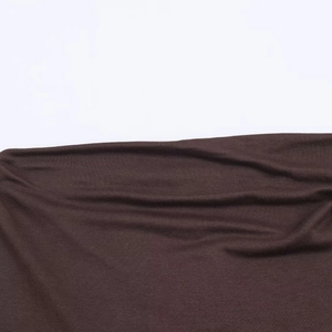 Detail of soft brown knitted fabric texture with natural folds and fine ribbed finish