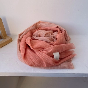 Detail of pink gradient cotton scarf showing soft breathable texture and fringe tassels