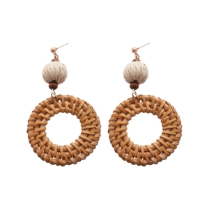 Bohemian rattan woven hoop earrings with cotton ball and wooden beads on white background