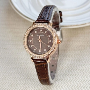 Elegant ladies vintage rose gold watch with brown leather strap and diamond bezel