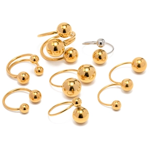 Minimalist spherical stainless steel rings in gold and silver finish on white background