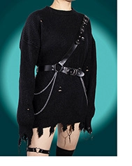 Detail of punk style black oversized sweater with distressed holes and metal chain belts