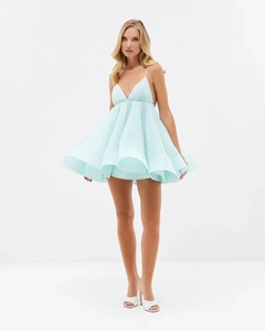 Detail of light blue pleated mini dress showing layered tulle fabric and spaghetti straps