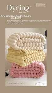 Close-up of soft faux rabbit fur blankets with 3D bubble texture in cream and pink