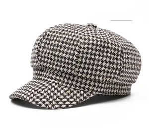 Detailed close-up of light khaki houndstooth pattern on a wool octagonal newsboy cap